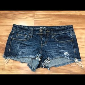 Low-rise distressed denim shorts